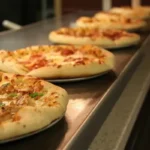 A line of industrially produced pizzas