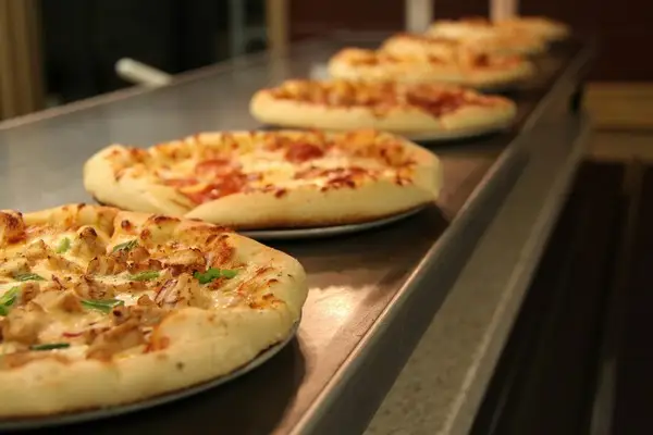 A line of industrially produced pizzas