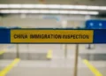 An airport barrier with the words 'China Imiigration Inspection".