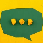 A speech bubble made from yellow and green card
