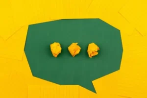 A speech bubble made from yellow and green card