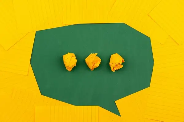A speech bubble made from yellow and green card