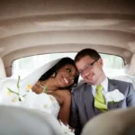 An interracial married couple just wed in the back of a car
