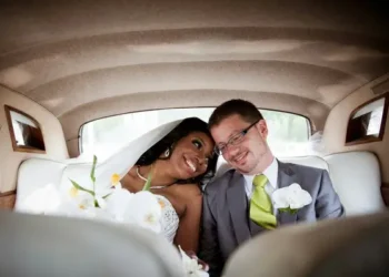 An interracial married couple just wed in the back of a car