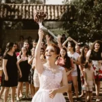 A bride throwing a bouquet of flowers to the wedding guests
