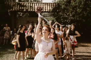 A bride throwing a bouquet of flowers to the wedding guests