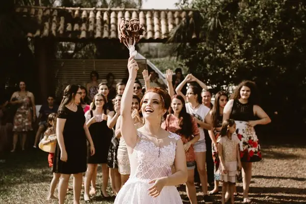 A bride throwing a bouquet of flowers to the wedding guests