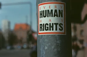 A sign on a lamppost stating 'every human has rights'