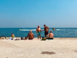 A group of older people sunbathing at the beach