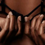 A person undoing their bra