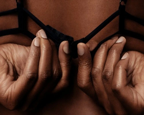 A person undoing their bra