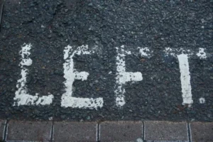 A road marking which says the word left