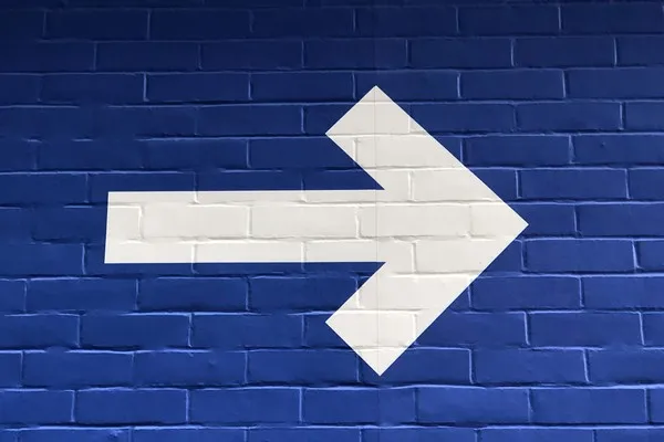 A white arrow pointing right against a blue background