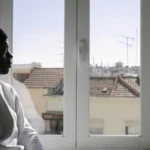 A guy looking out of the window