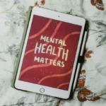 An Ipad with the words 'mental health matters' displayed on the screen.