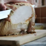 Somebody slicing a turkey for christmas dinner