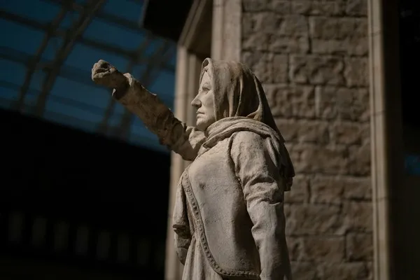 A statue of a woman with her fist in the air