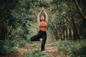 A woman performing a yoga stance in the forest