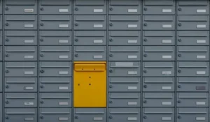A grey set of drawer units with a single yellow draw.
